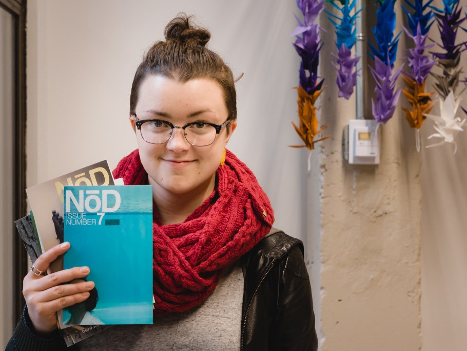 katie holding several back issues of NōD magazine, 2015; photograph by Jason Herring